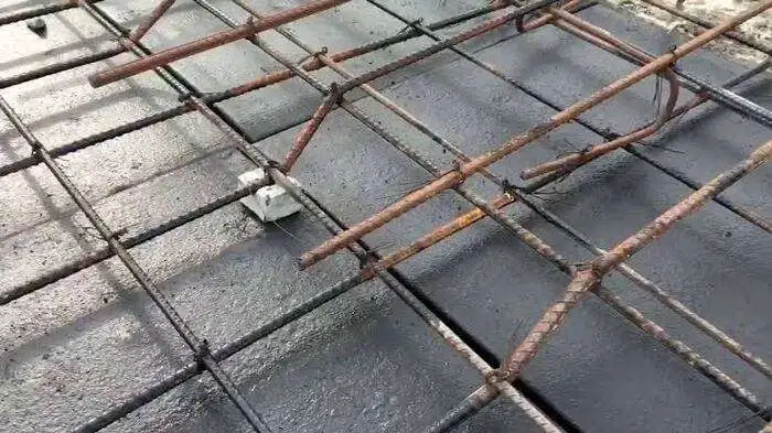 Reinforcement bars (rebars) placed on top of a concrete slab formwork, with visible crank bars for added structural support.